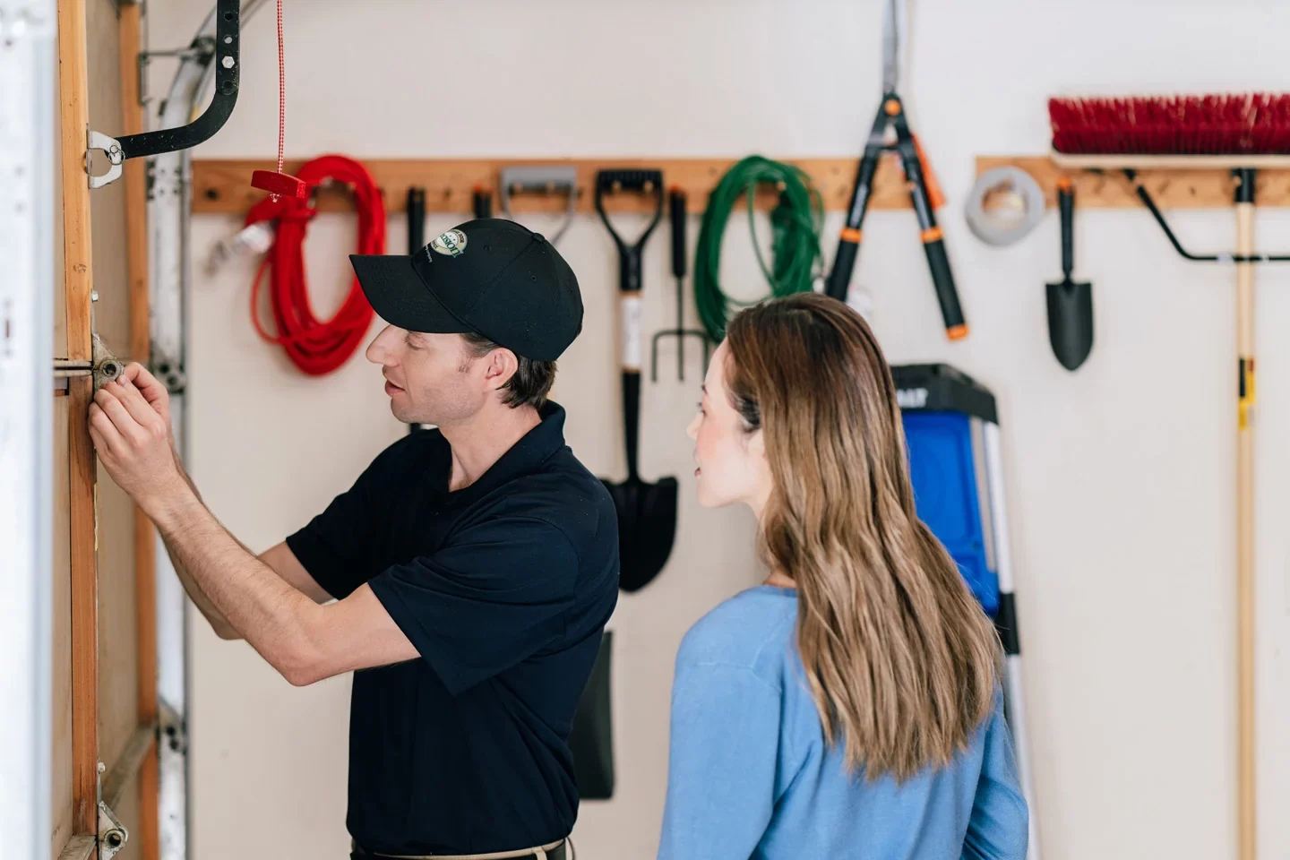 Precision technician inspecting a garage door (1) Precision technician inspecting a garage door